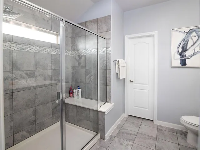 a bathroom with a shower and toilet