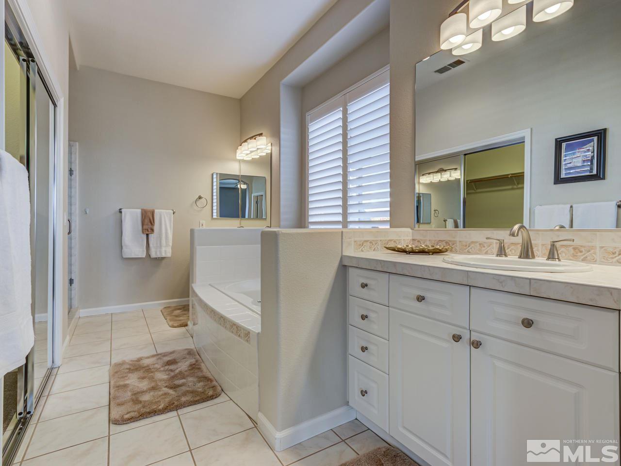 5837 North White Sands Road Reno, NV 89511 - Photo 11 of 22 a bathroom with a sink a vanity and a mirror