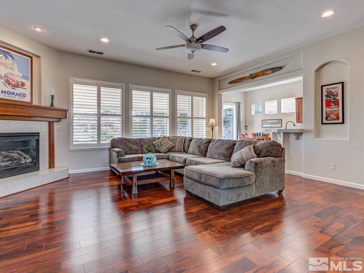 5837 North White Sands Road Reno, NV 89511 - Photo 3 of 22 a living room with furniture and a fireplace