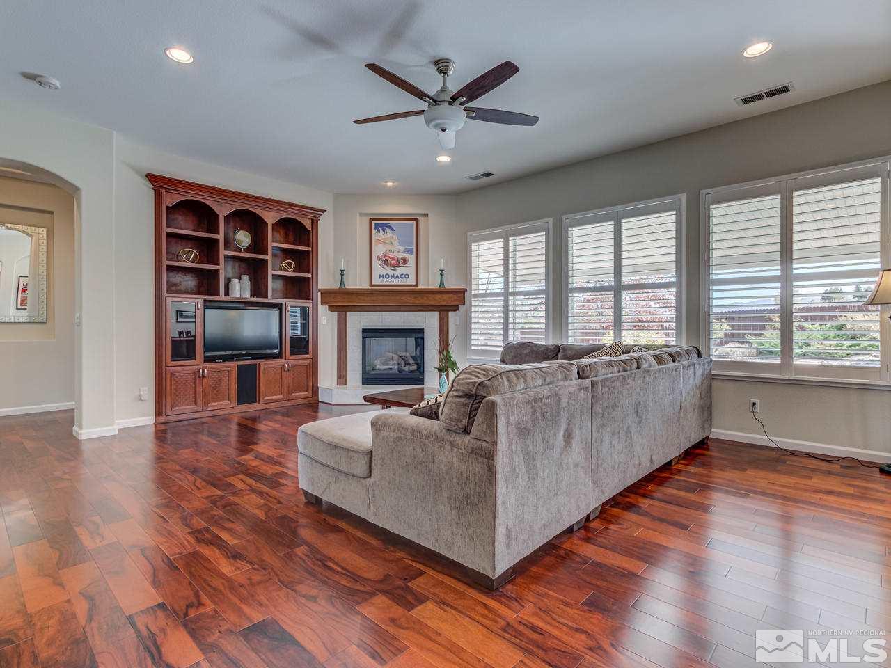 5837 North White Sands Road Reno, NV 89511 - Photo 5 of 22 a living room with furniture and a fireplace