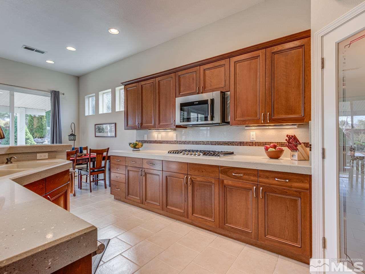 5837 North White Sands Road Reno, NV 89511 - Photo 7 of 22 a kitchen with a sink refrigerator and cabinets