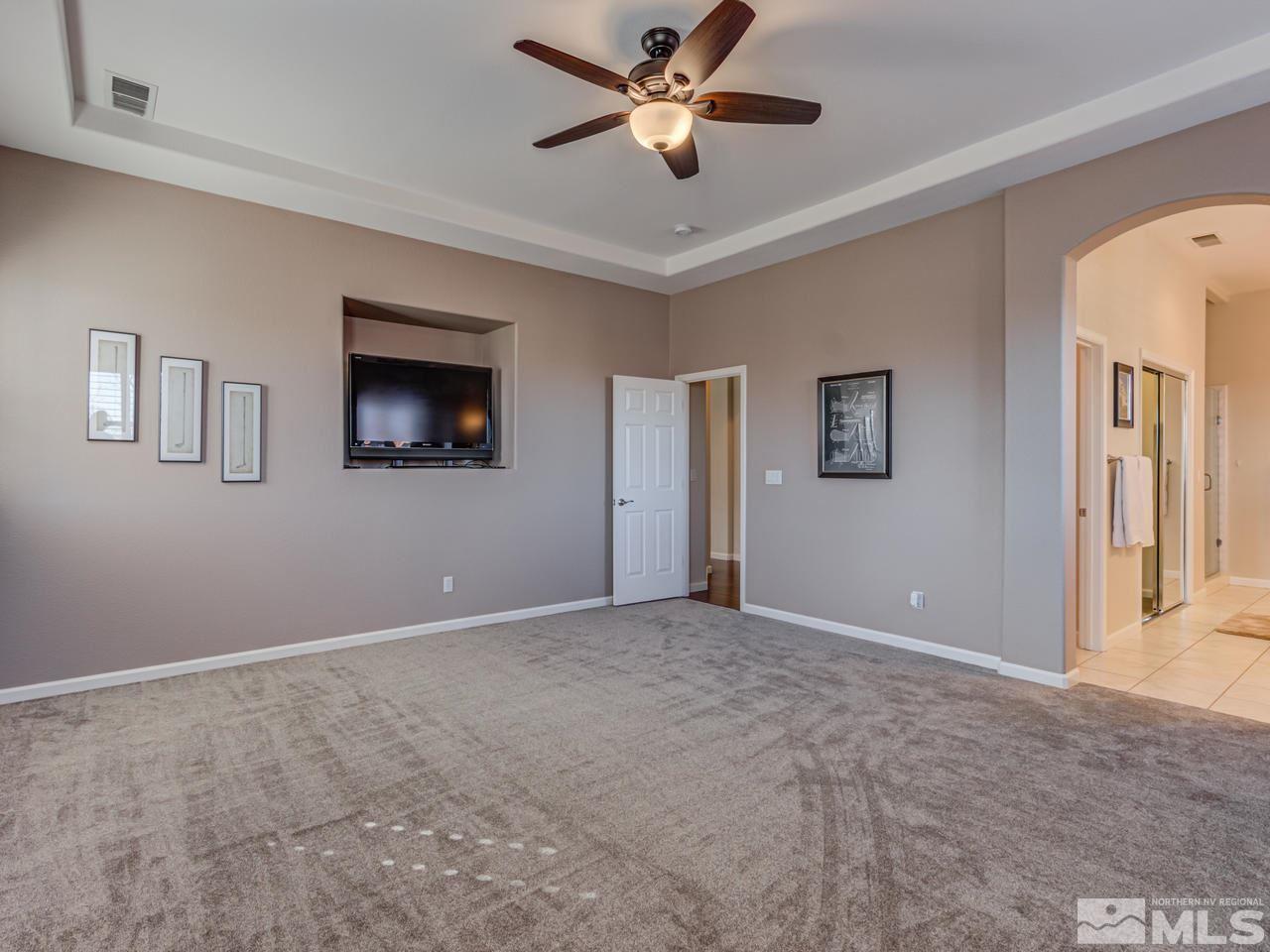 5837 North White Sands Road Reno, NV 89511 - Photo 10 of 22 a view of an empty room with a ceiling fan