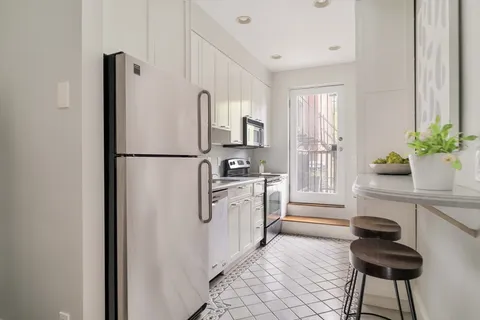 a kitchen with stainless steel appliances a refrigerator and a stove