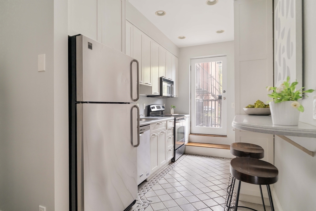 530 Massachusetts Avenue, Unit 2 Boston, MA 02118 - Photo 11 of 33 a kitchen with stainless steel appliances a refrigerator and a stove