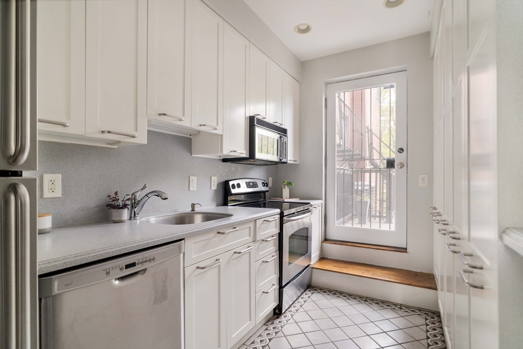 530 Massachusetts Avenue, Unit 2 Boston, MA 02118 - Photo 12 of 33 a kitchen with stainless steel appliances granite countertop a sink stove and refrigerator