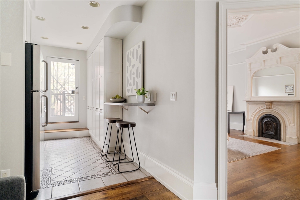 530 Massachusetts Avenue, Unit 2 Boston, MA 02118 - Photo 13 of 33 a view of a livingroom with furniture wooden floor a fireplace and windows
