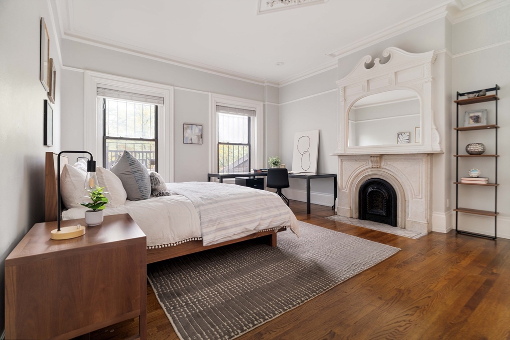 530 Massachusetts Avenue, Unit 2 Boston, MA 02118 - Photo 14 of 33 a bedroom with a bed and a fireplace