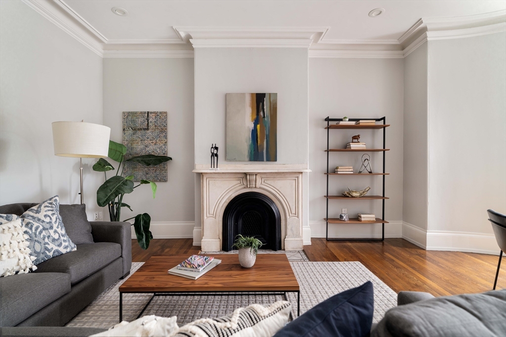 530 Massachusetts Avenue, Unit 2 Boston, MA 02118 - Photo 2 of 33 a living room with furniture and a fireplace