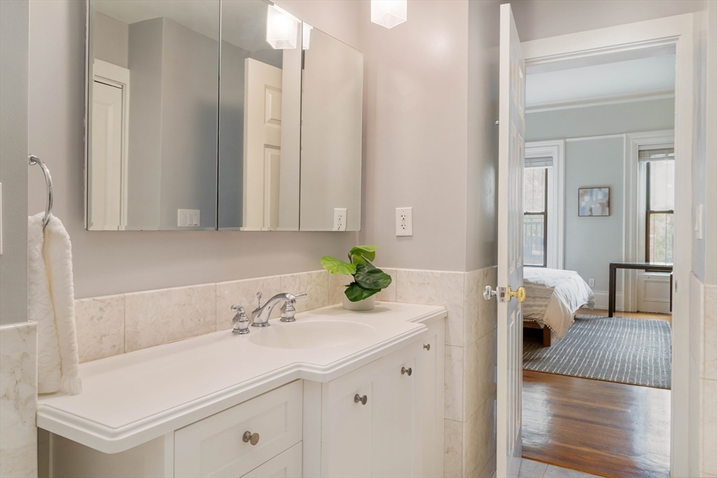 530 Massachusetts Avenue, Unit 2 Boston, MA 02118 - Photo 21 of 33 a bathroom with a sink and a mirror