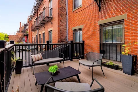 a view of a chairs and table in the balcony