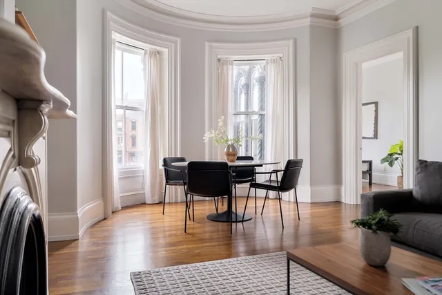 a living room with fireplace furniture and a wooden floor