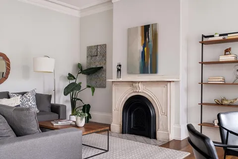 a living room with furniture and a fireplace