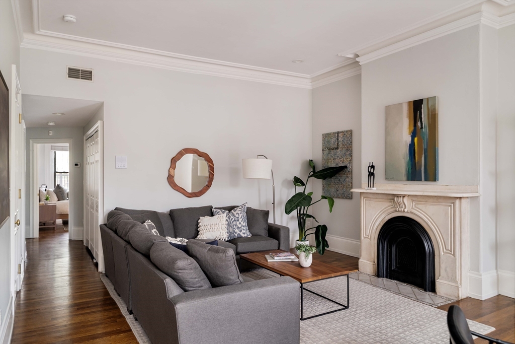 530 Massachusetts Avenue, Unit 2 Boston, MA 02118 - Photo 7 of 33 a living room with furniture a fireplace and a window