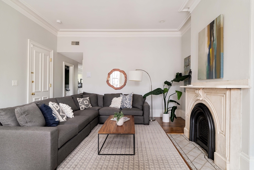 530 Massachusetts Avenue, Unit 2 Boston, MA 02118 - Photo 8 of 33 a living room with furniture and a fireplace
