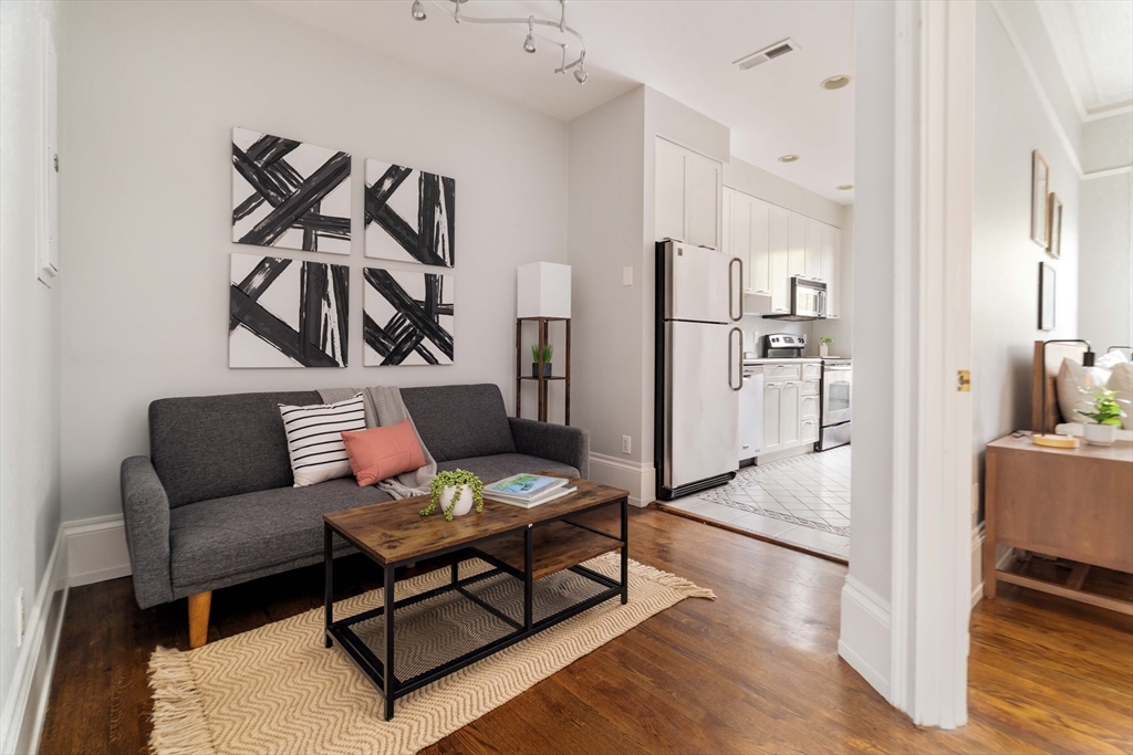 530 Massachusetts Avenue, Unit 2 Boston, MA 02118 - Photo 9 of 33 a living room with furniture and wooden floor