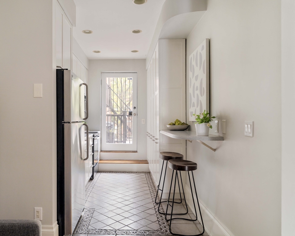 530 Massachusetts Avenue, Unit 2 Boston, MA 02118 - Photo 10 of 33 a view of a hallway with windows and couch