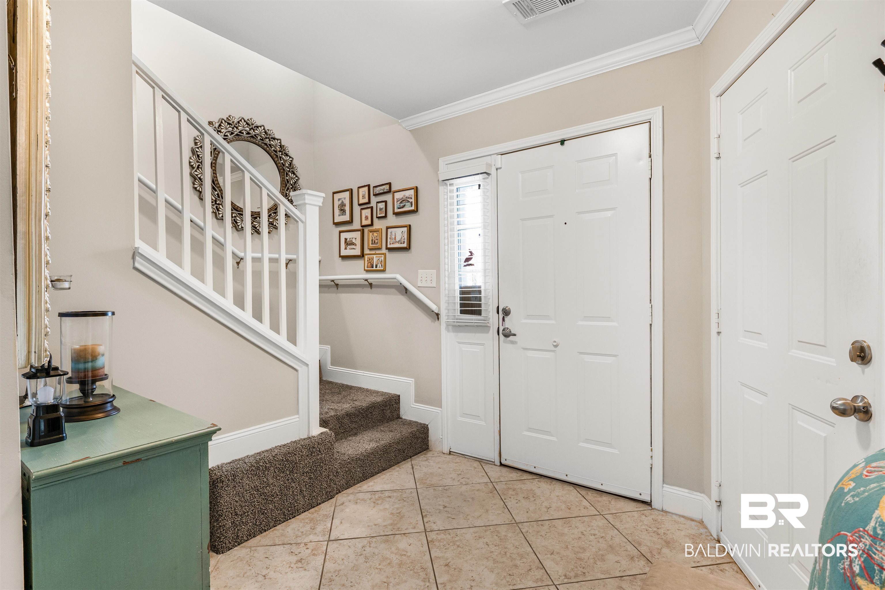 1517 Regency Road, Unit 68 Gulf Shores, AL 36542 - Photo 7 of 43 Tiled entrance foyer featuring crown molding