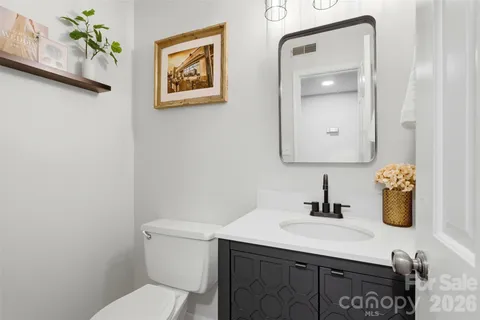 a bathroom with a sink a toilet and mirror