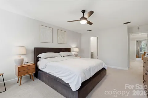 a bedroom with a bed and a lamp