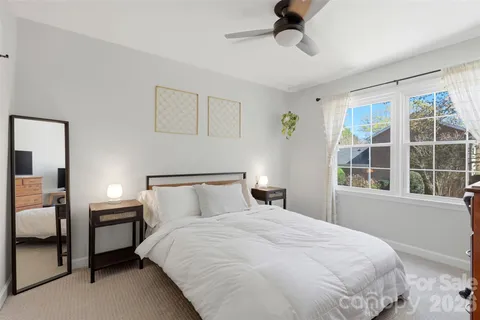 a bedroom with a large bed and a window