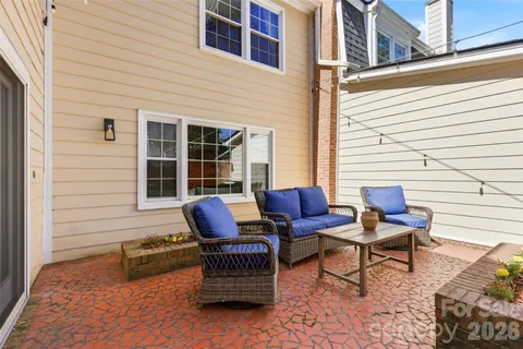 a wooden bench sitting in front of a house