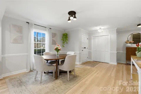 a view of a dining room with furniture and a potted plant