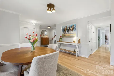 a dining room with furniture and wooden floor