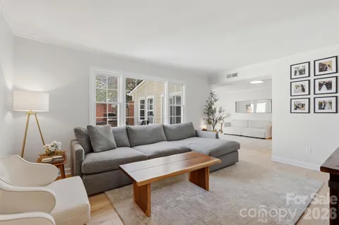 a living room with furniture and a lamp
