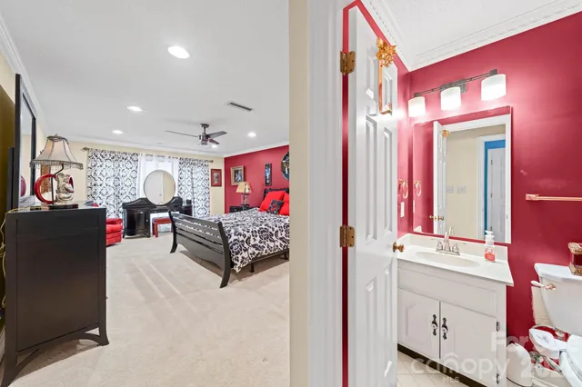 a bathroom with a sink vanity mirror and toilet