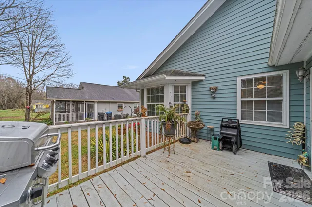 a view of a balcony with wooden floor and iron stairs