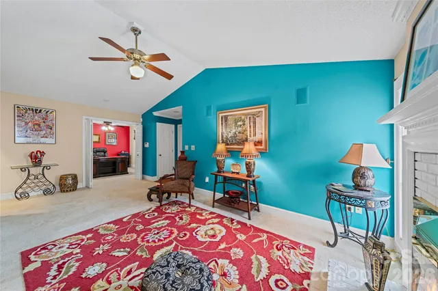 a living room with furniture a air conditioner and a window