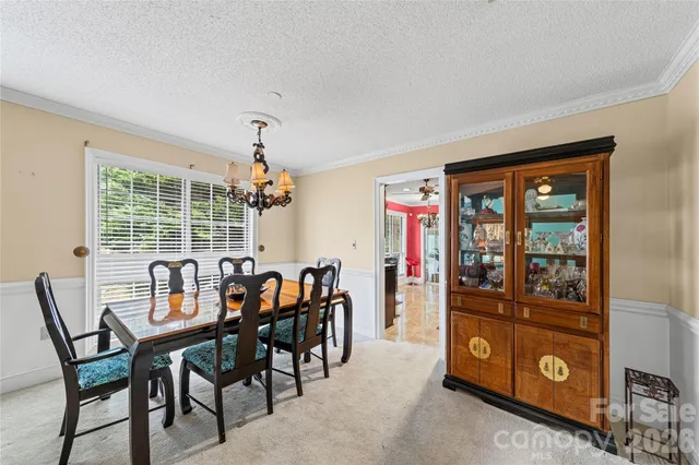 a view of a dining room with furniture and chandelier