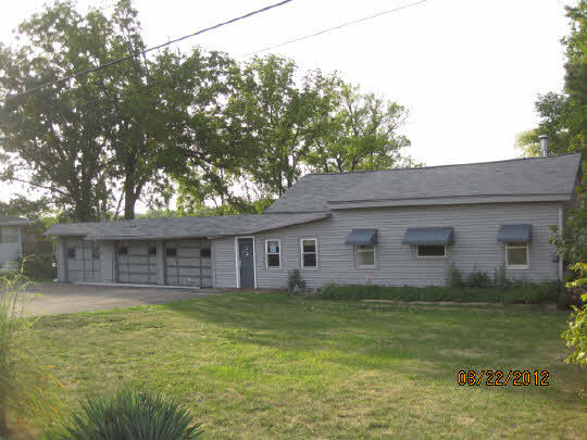 7488 North River Road Byron, IL 61010 - Photo 1 of 11 a front view of house with yard