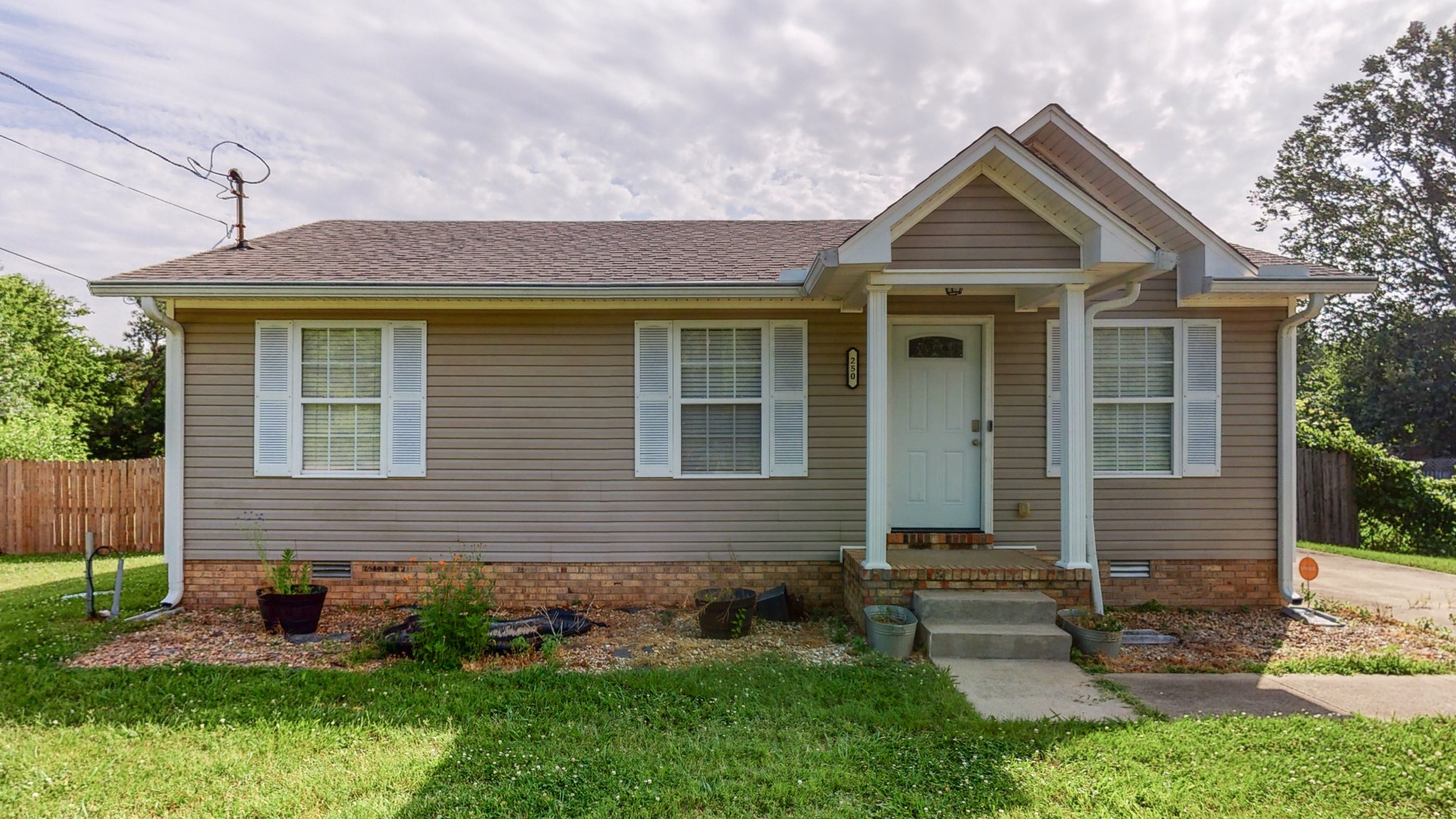 250 Hugh Hunter Road Oak Grove, KY 42262 - Photo 1 of 33 a front view of a house with garden