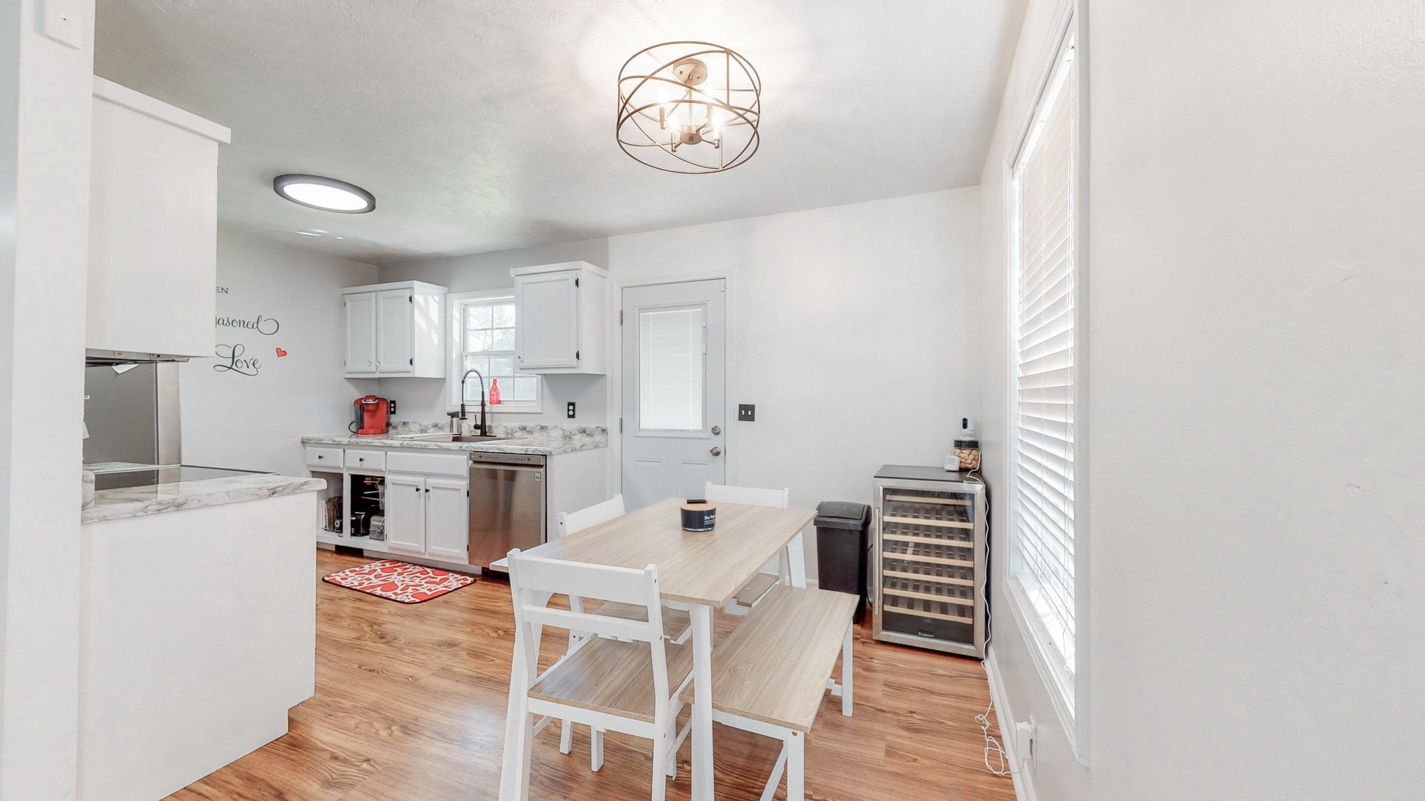 250 Hugh Hunter Road Oak Grove, KY 42262 - Photo 6 of 33 a kitchen with a dining table chairs and white cabinets