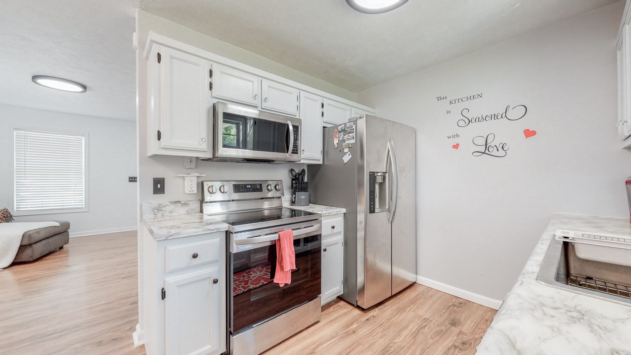 250 Hugh Hunter Road Oak Grove, KY 42262 - Photo 10 of 33 a kitchen with stainless steel appliances a stove microwave and a refrigerator
