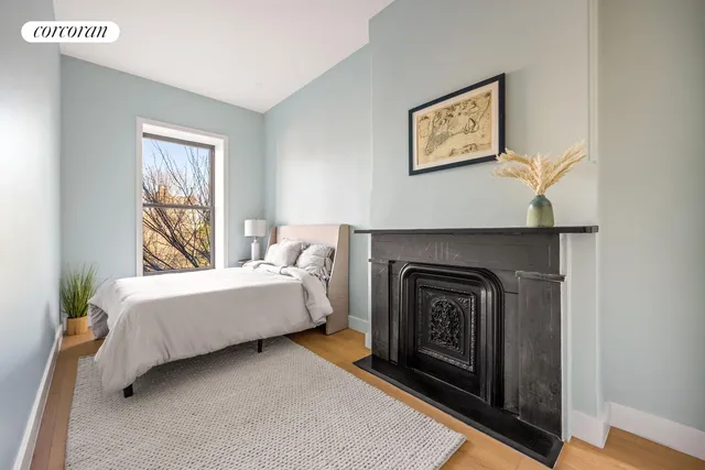 a spacious bedroom with a bed and a fireplace