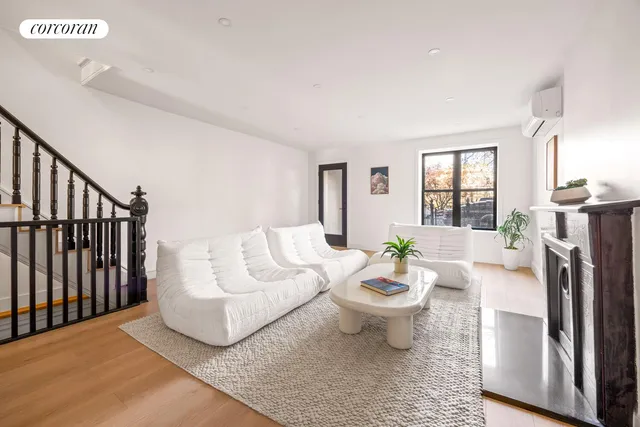 a living room with furniture a fireplace and a table