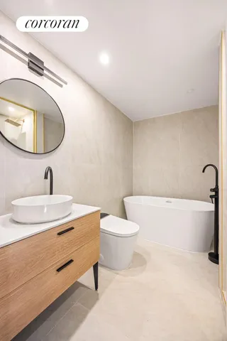 a bathroom with a toilet a sink and bathtub