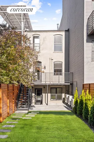 a front view of a house with a yard table and chairs