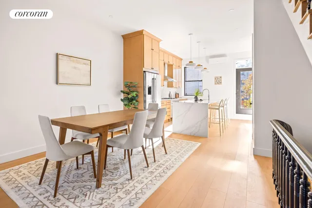 a dining room with furniture and wooden floor