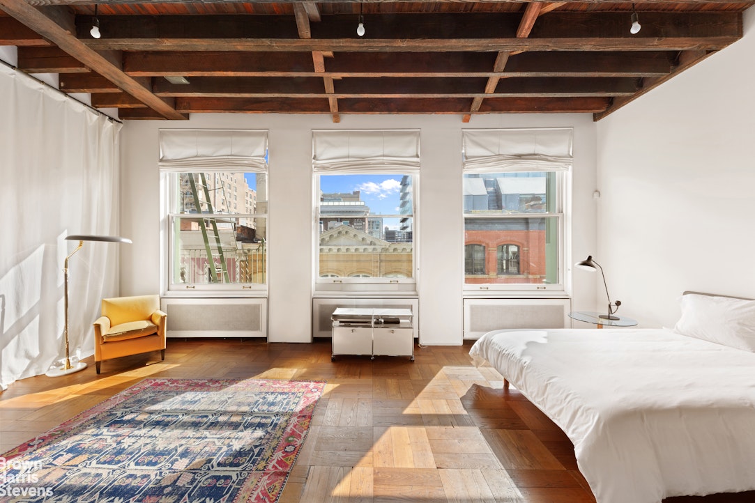 41 Greene Street, Unit 5 Manhattan, NY 10013 - Photo 6 of 10 a bedroom with furniture and windows