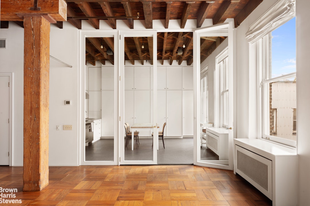 41 Greene Street, Unit 5 Manhattan, NY 10013 - Photo 7 of 10 a view of front door with hallway and furniture