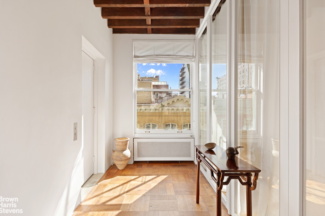 41 Greene Street, Unit 5 Manhattan, NY 10013 - Photo 9 of 10 a view of a room with a bed and a window
