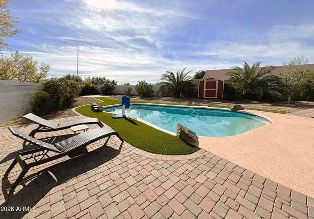 a view of a swimming pool with a lounge chair