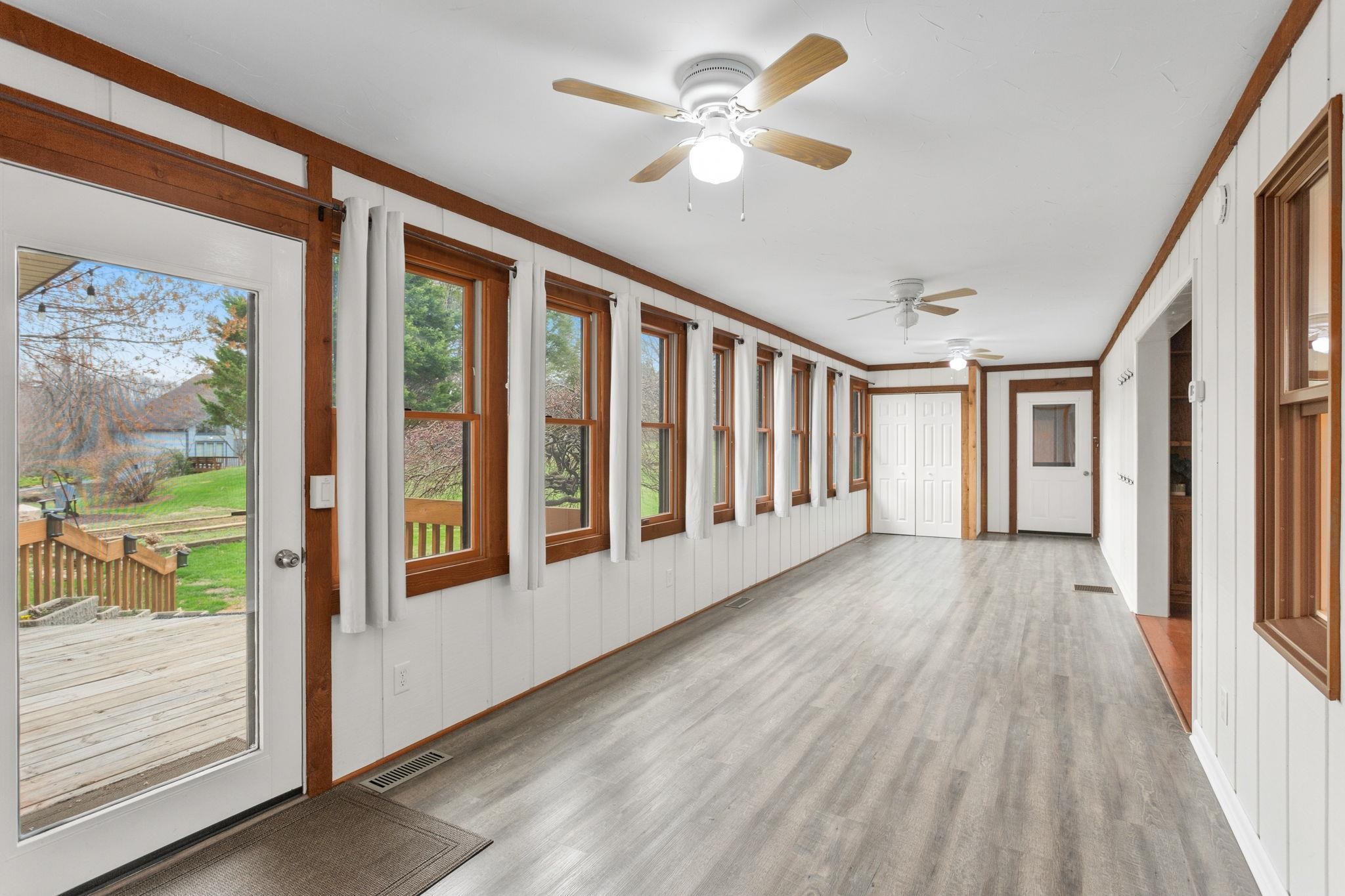 3210 Arrowhead Road Harrisonburg, VA 22801 - Photo 15 of 44 a view of a hallway with wooden floor and a ceiling fan