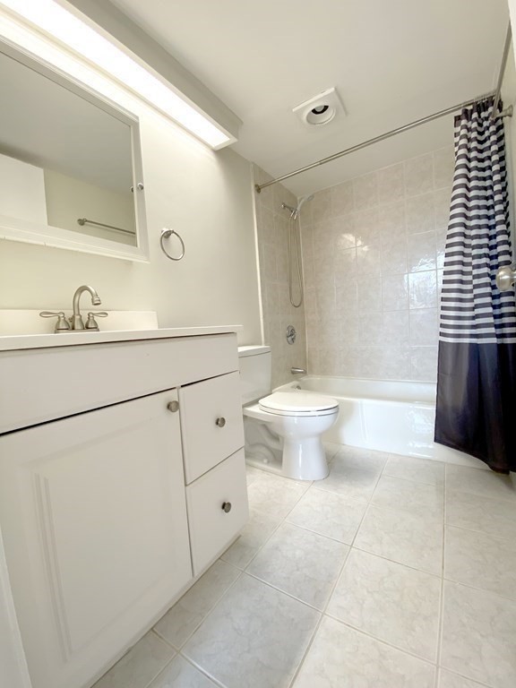 85 Brainerd Road, Unit 503 Boston, MA 02134 - Photo 10 of 21 a bathroom with a toilet sink and mirror