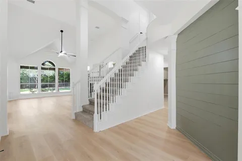 a view of entryway and hall with wooden floor