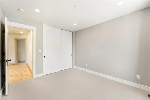 an empty room with windows and closet