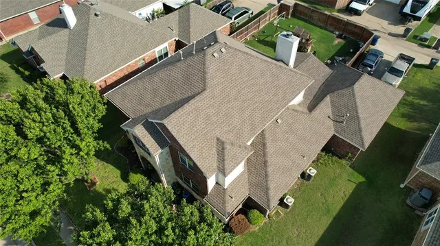 an aerial view of a house with a yard